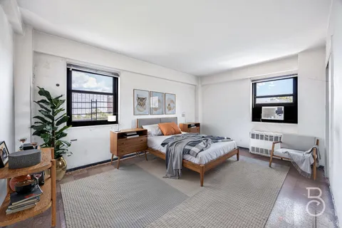 a bedroom with furniture and a window