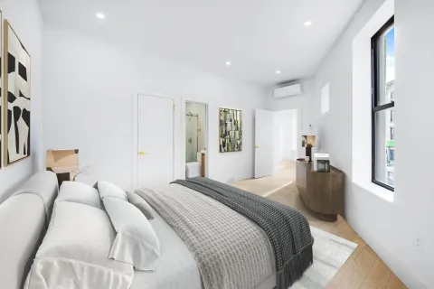 a bedroom with a bed and a couch