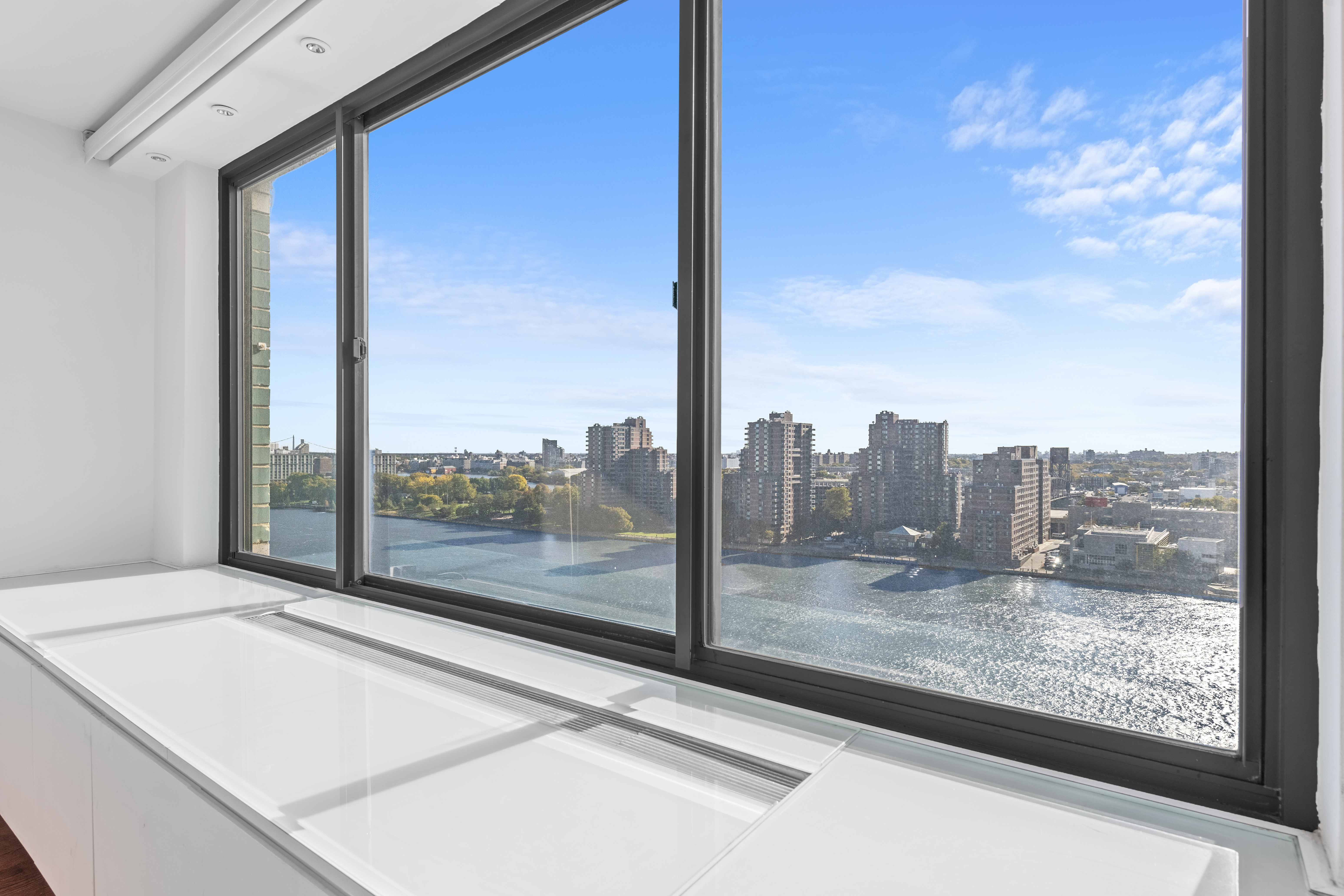 530 East 72nd Street, Unit 14E Manhattan, NY 10021 - Photo 5 of 19 a view of a room with wooden floor and a floor to ceiling window