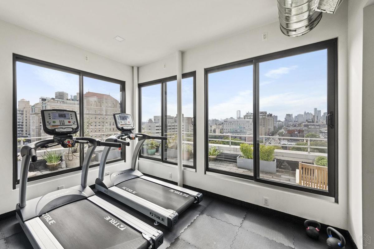 305 2nd Avenue, Unit 518 Manhattan, NY 10003 - Photo 18 of 19 a room with gym equipment and large windows