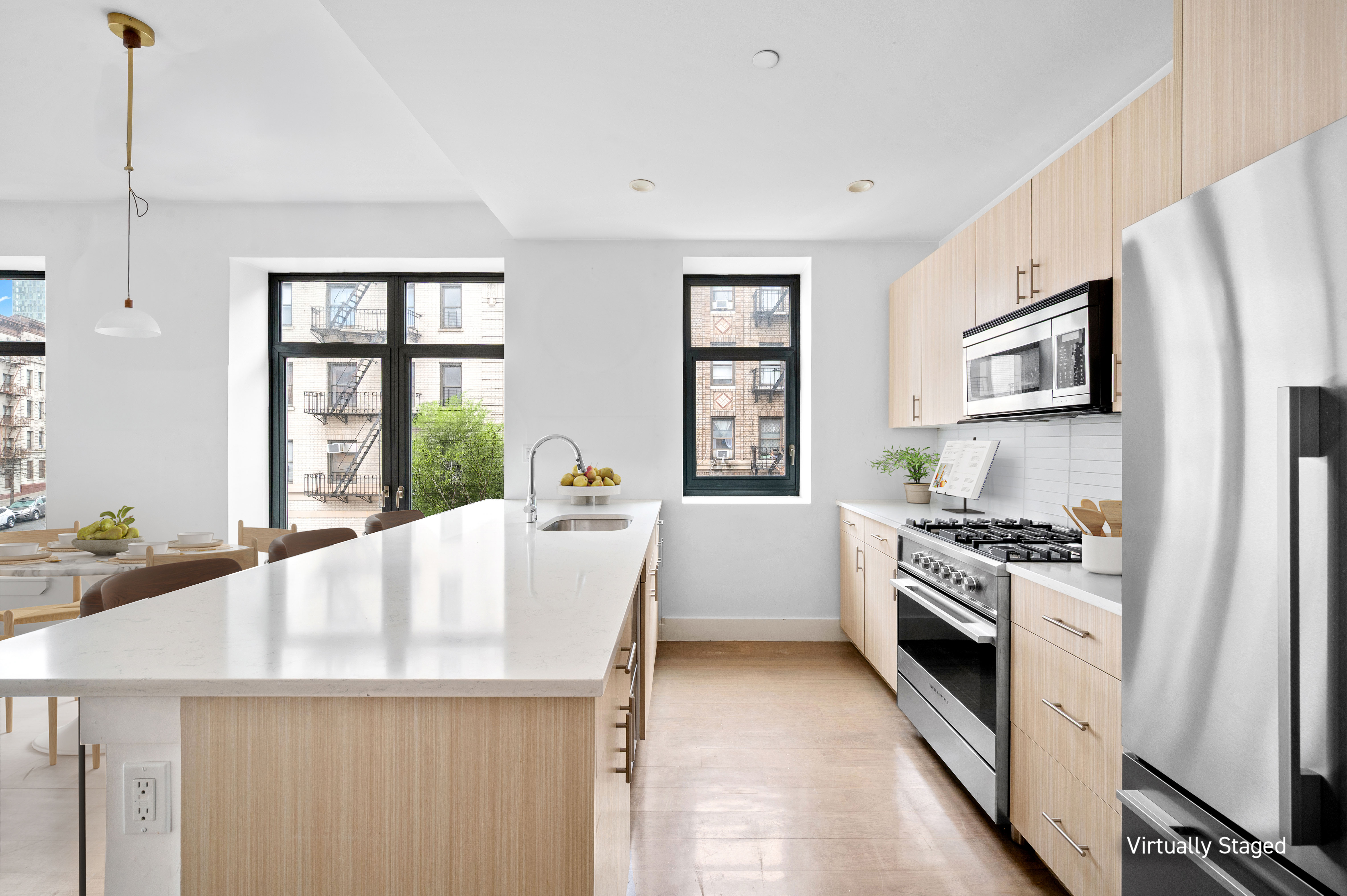 17 Convent Avenue Manhattan, NY 10027 - Photo 3 of 15 a kitchen with stainless steel appliances a stove a sink and a refrigerator