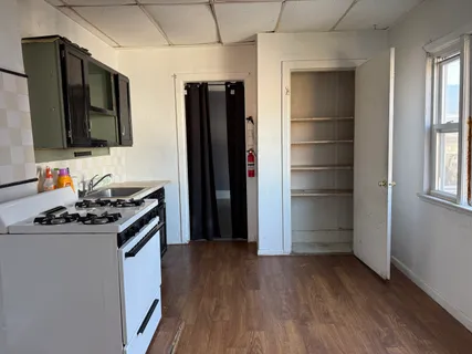 a kitchen with a refrigerator and a stove top oven