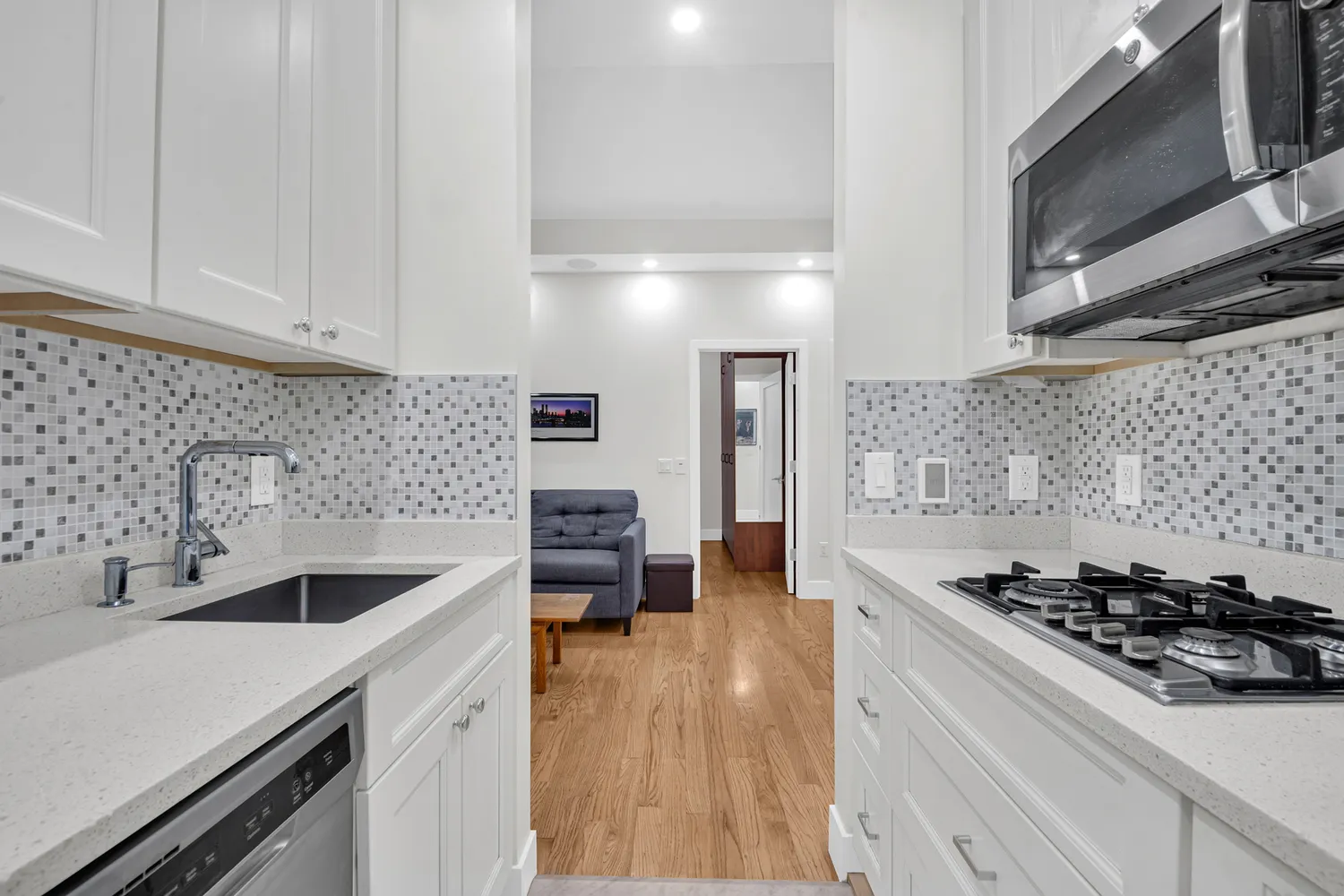 a kitchen with a sink a stove and cabinets