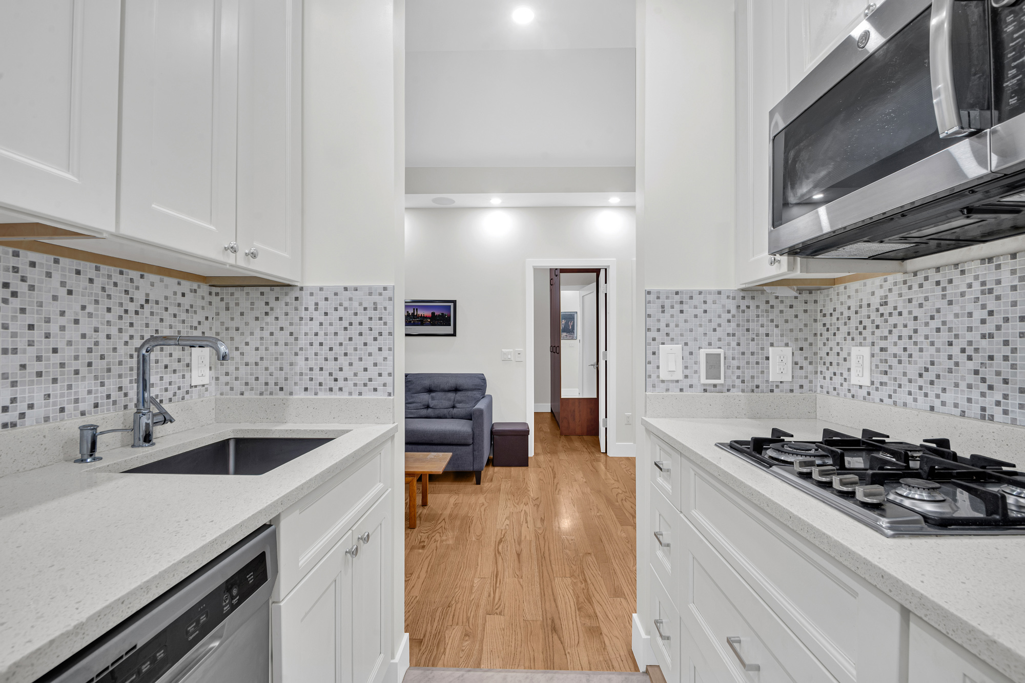 244 Riverside Drive, Unit 5K Manhattan, NY 10025 - Photo 2 of 8 a kitchen with a sink a stove and cabinets