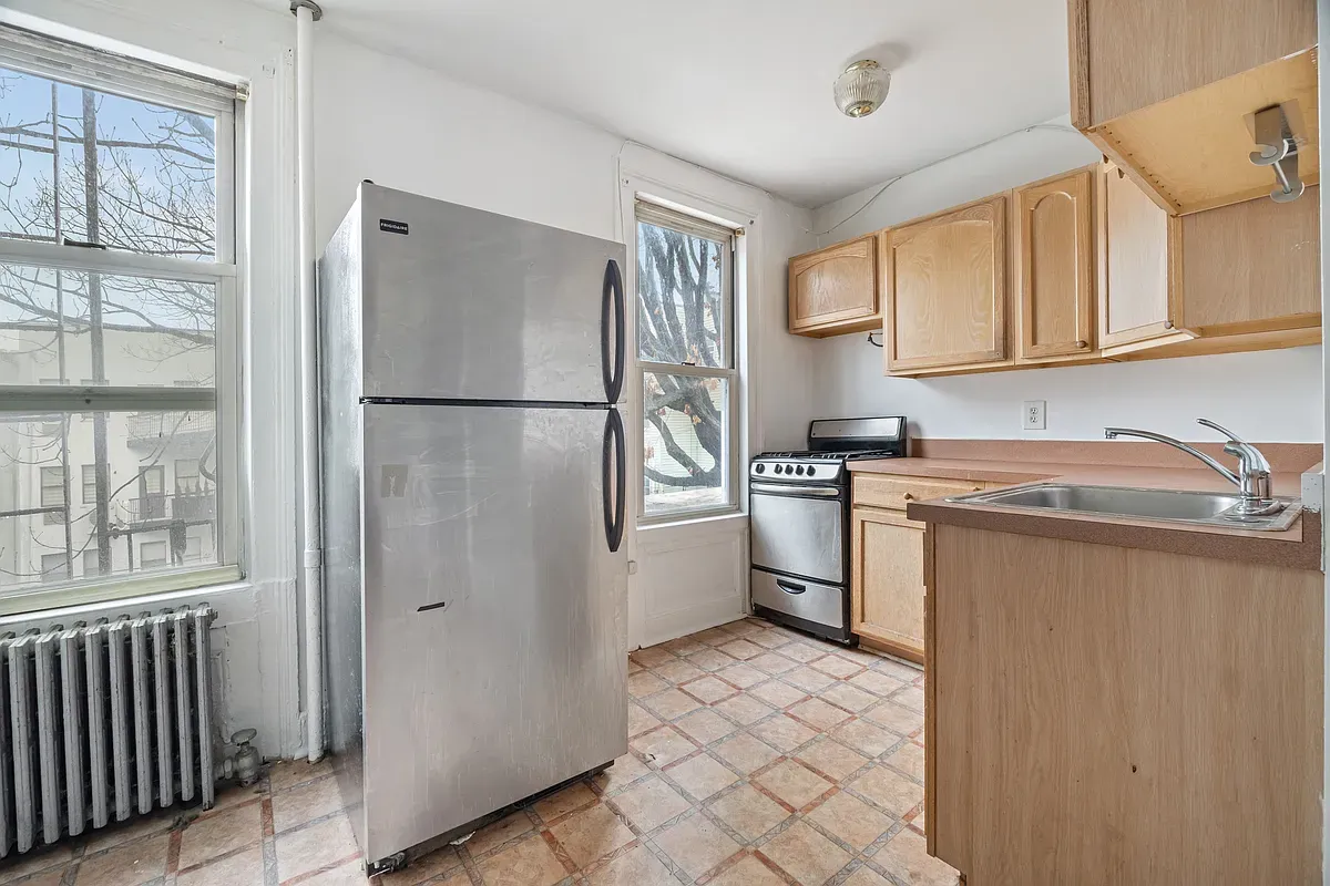 a kitchen with a refrigerator sink and cabinets