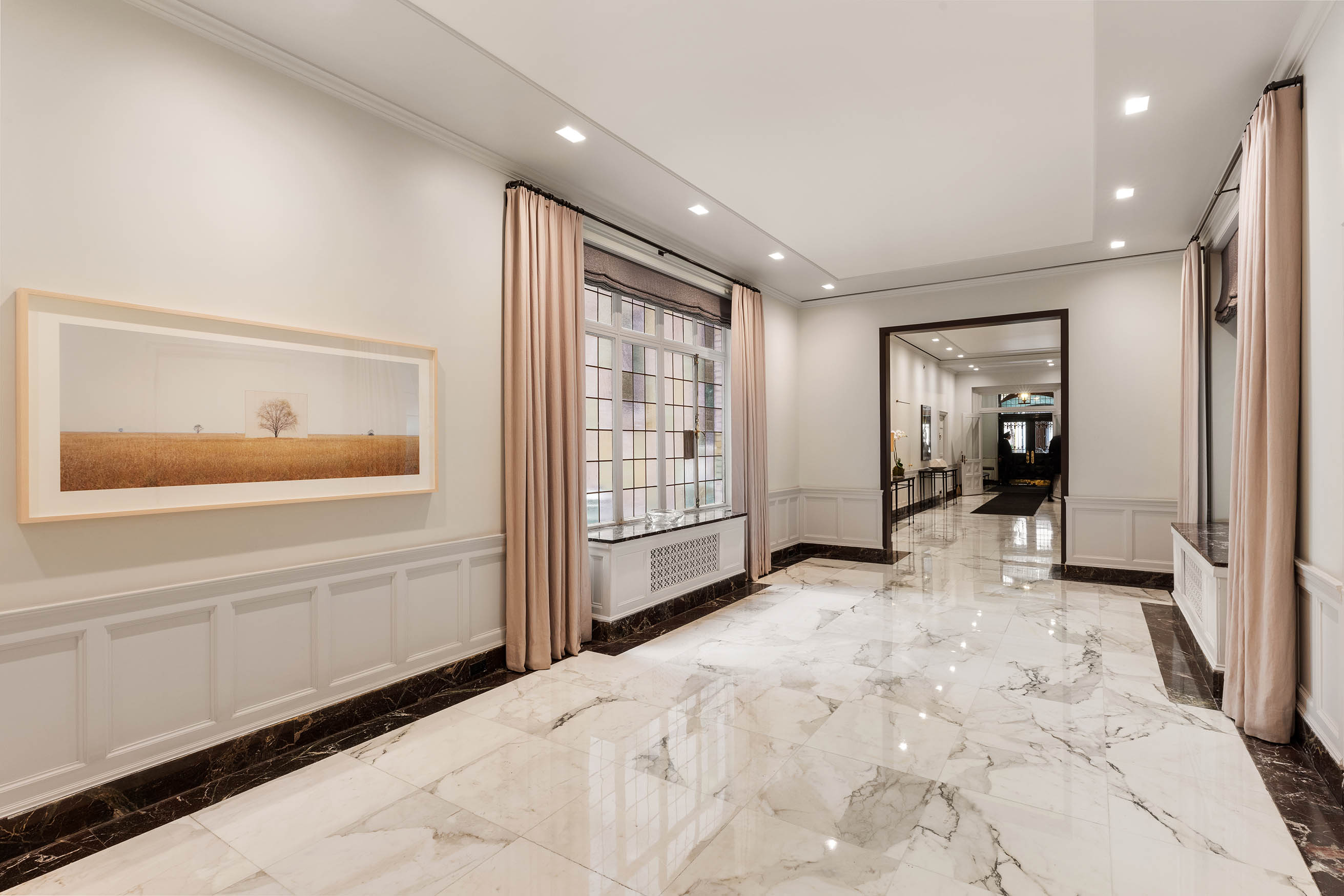 33 East 70th Street, Unit 9C Manhattan, NY 10021 - Photo 9 of 12 a view of a hallway with bathroom and mirror
