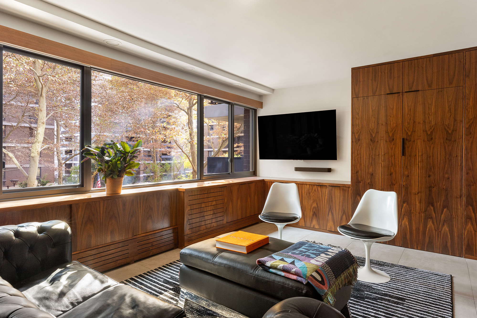 66 Frankfort Street, Unit 3L Manhattan, NY 10038 - Photo 3 of 7 a living room with furniture and a flat screen tv