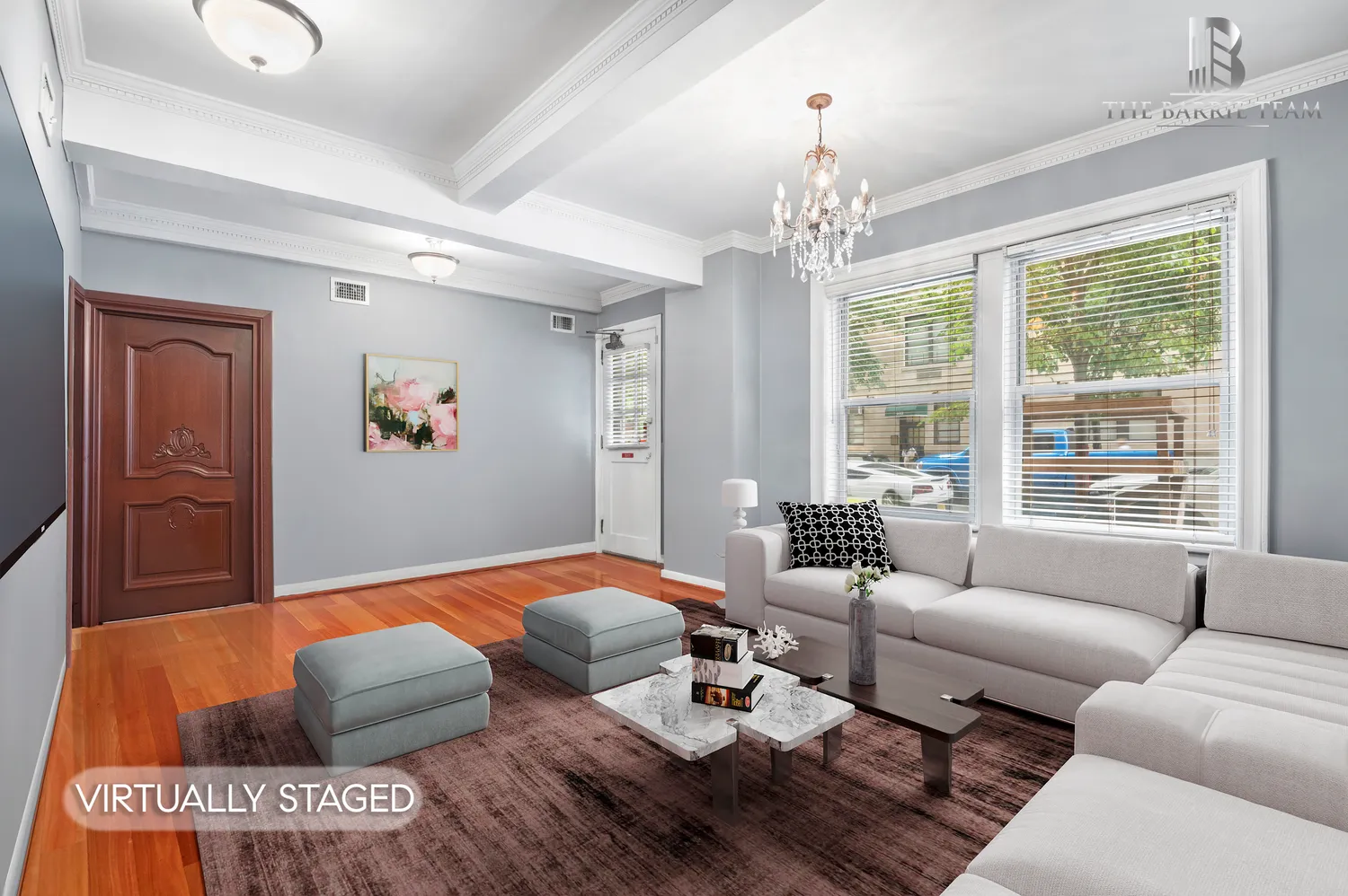 a living room with furniture and a chandelier