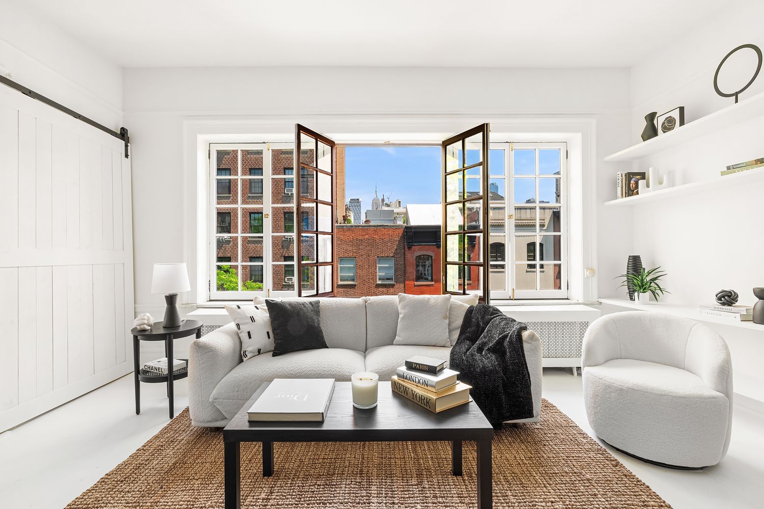 30-32 West 9th Street, Unit 5A Manhattan, NY 10011 - Photo 5 of 18 a living room with furniture and a large window
