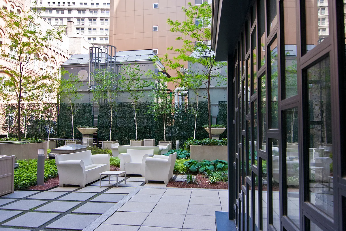99 John Street, Unit 208 Manhattan, NY 10038 - Photo 16 of 18 a view of a patio with couches and potted plants