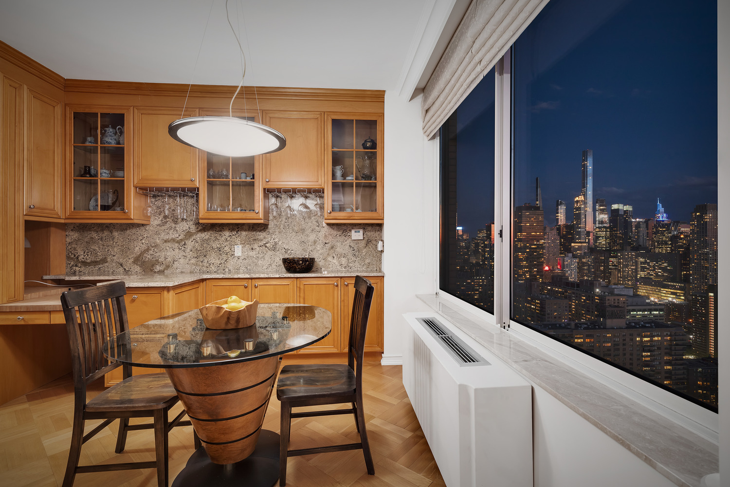 200 Riverside Boulevard, Unit 44A Manhattan, NY 10069 - Photo 19 of 22 a kitchen with a table and chairs