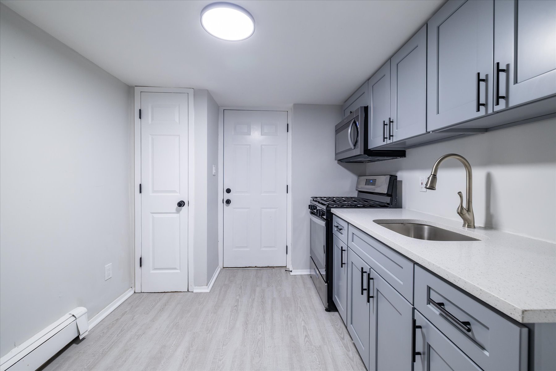 13-03 Brunswick Avenue Queens, NY 11691 - Photo 22 of 27 a kitchen with stainless steel appliances granite countertop a sink stove and cabinets