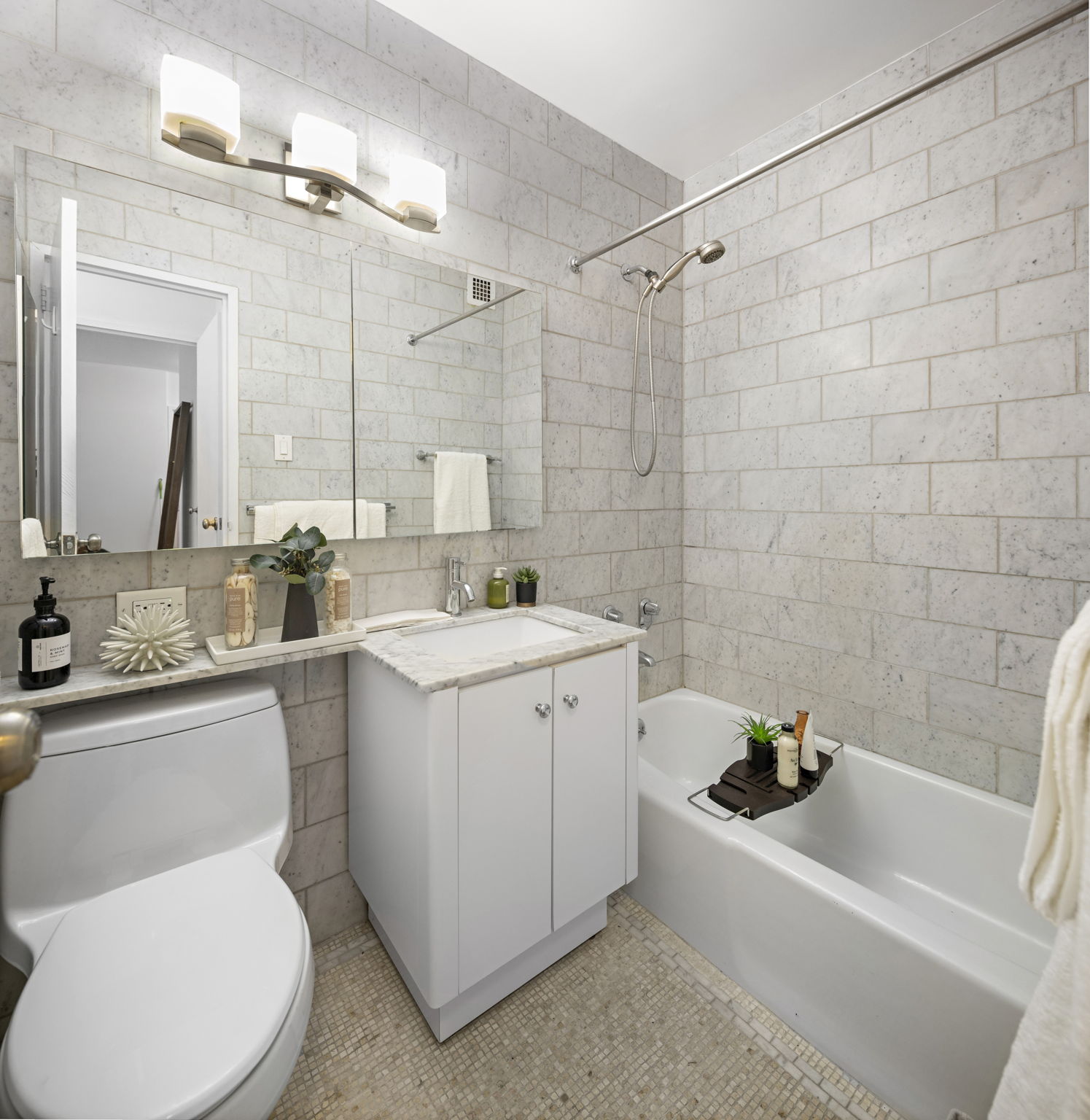 400 East 54th Street, Unit 18E Manhattan, NY 10022 - Photo 12 of 22 a bathroom with a sink mirror toilet and bathtub