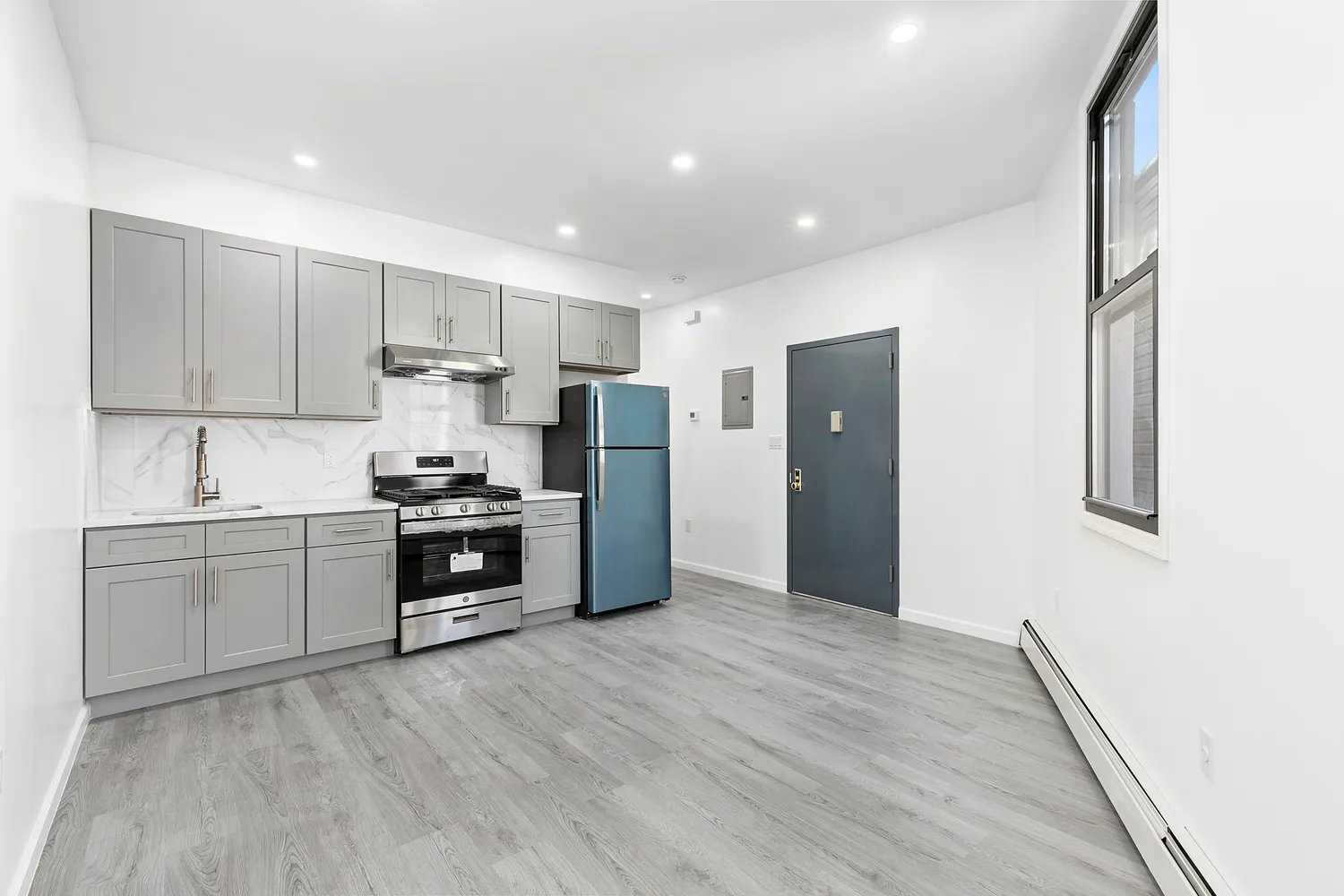 a kitchen with stainless steel appliances a refrigerator sink and stove