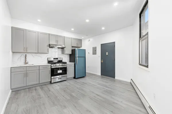 a kitchen with stainless steel appliances a refrigerator sink and stove