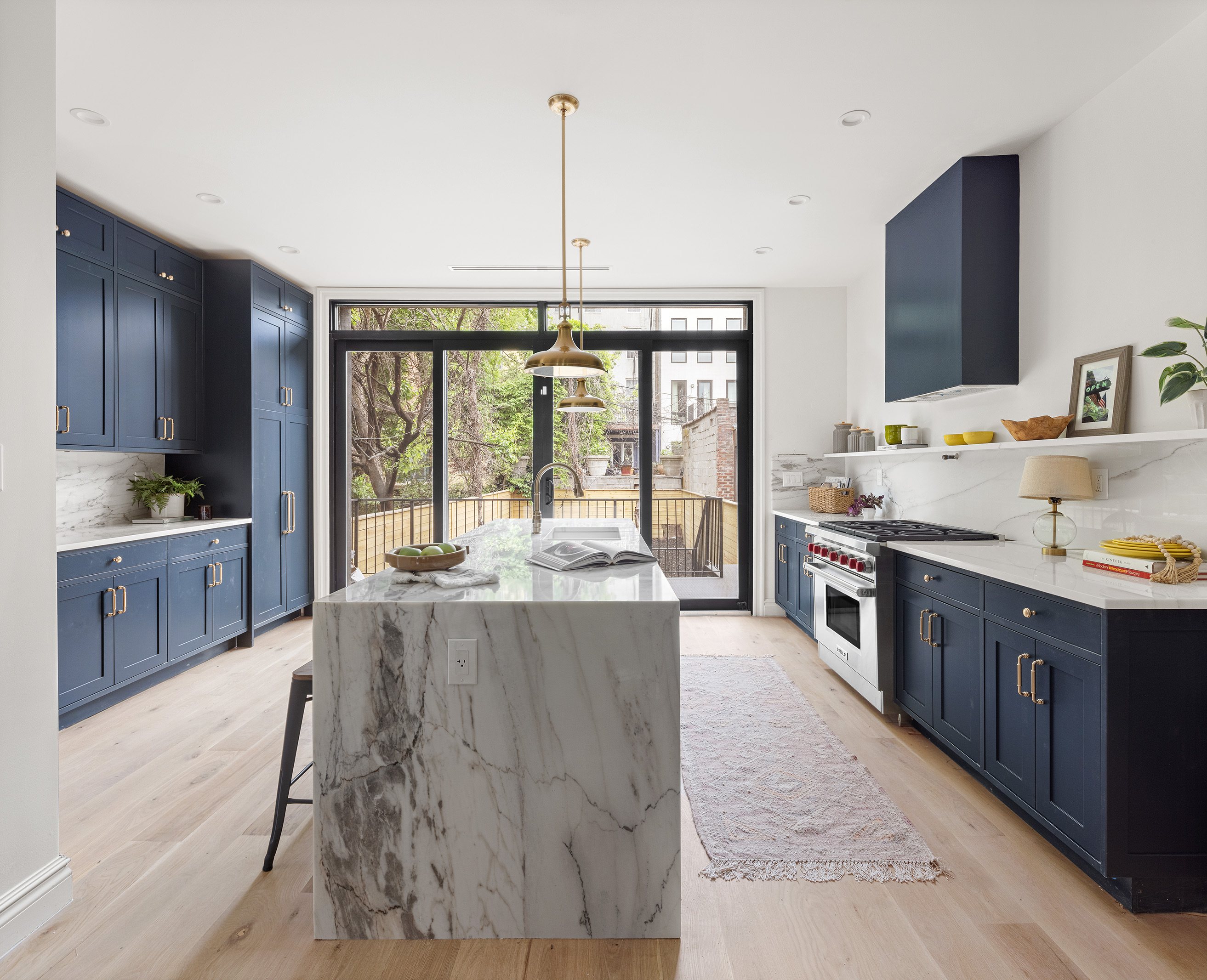 363 Warren Street Brooklyn, NY 11201 - Photo 5 of 23 a large kitchen with kitchen island a large counter top space a sink stainless steel appliances and cabinets