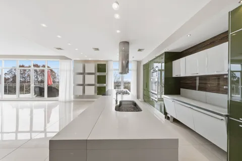 a living room with furniture windows and white walls