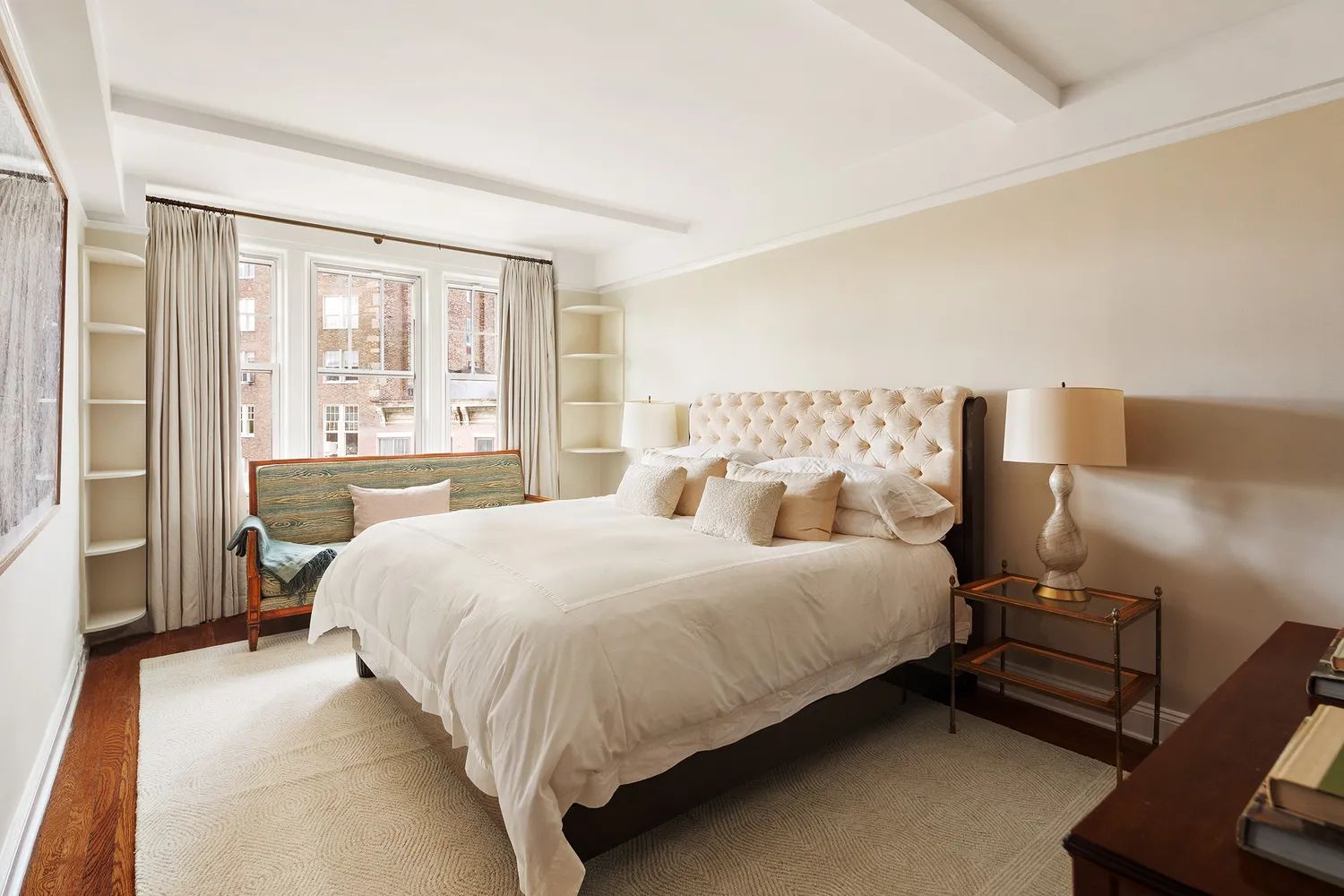 a bedroom with a bed and large window