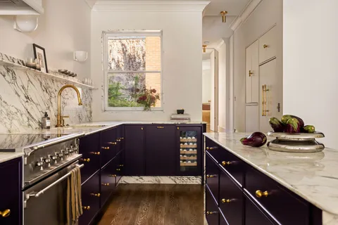 a view of a livingroom with furniture a fireplace and wooden floor