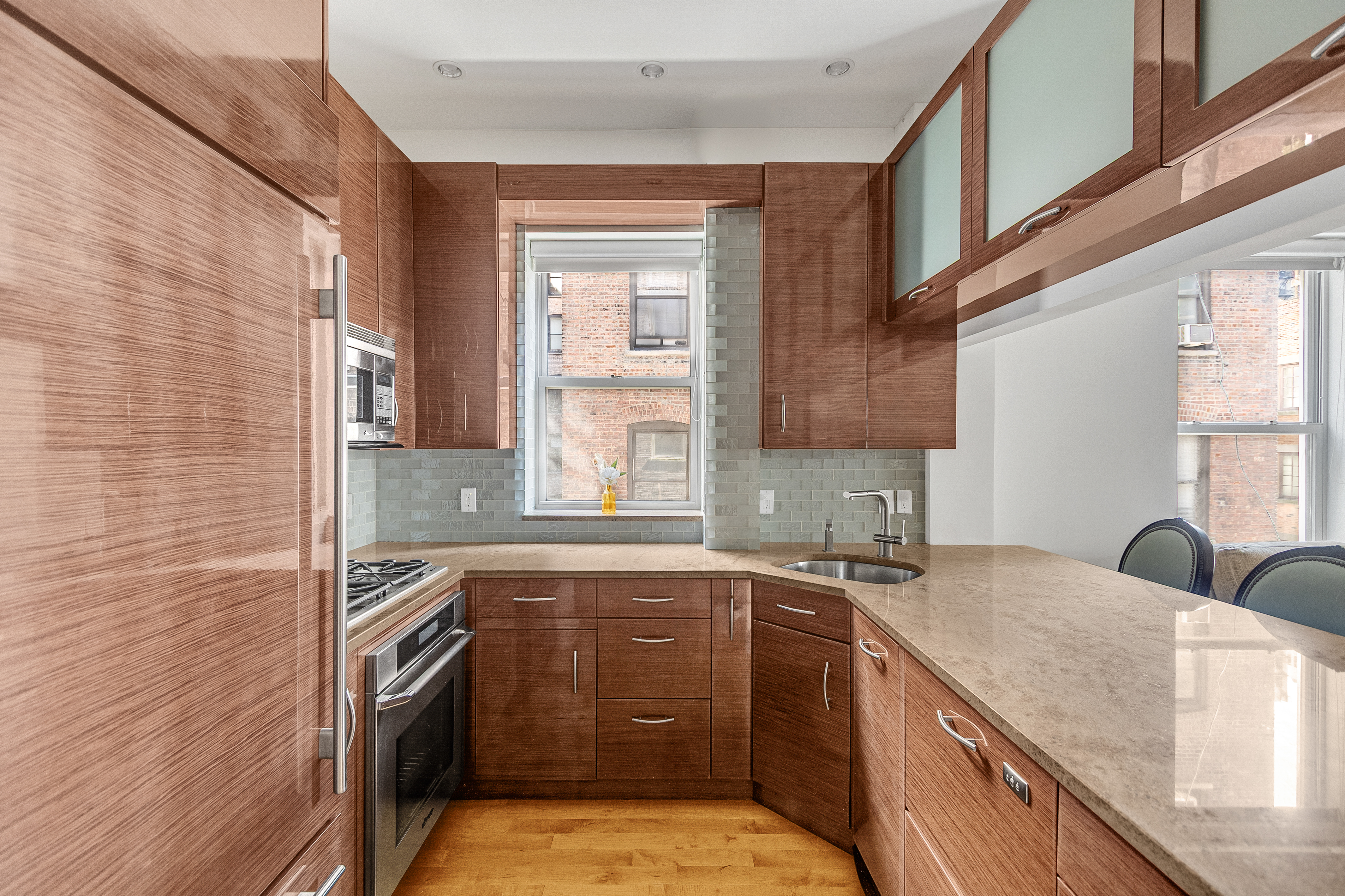 345 West 70th Street, Unit 4E Manhattan, NY 10023 - Photo 4 of 11 a kitchen with a sink stove and cabinets