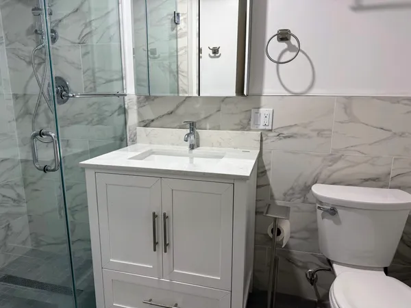a bathroom with a toilet sink and shower