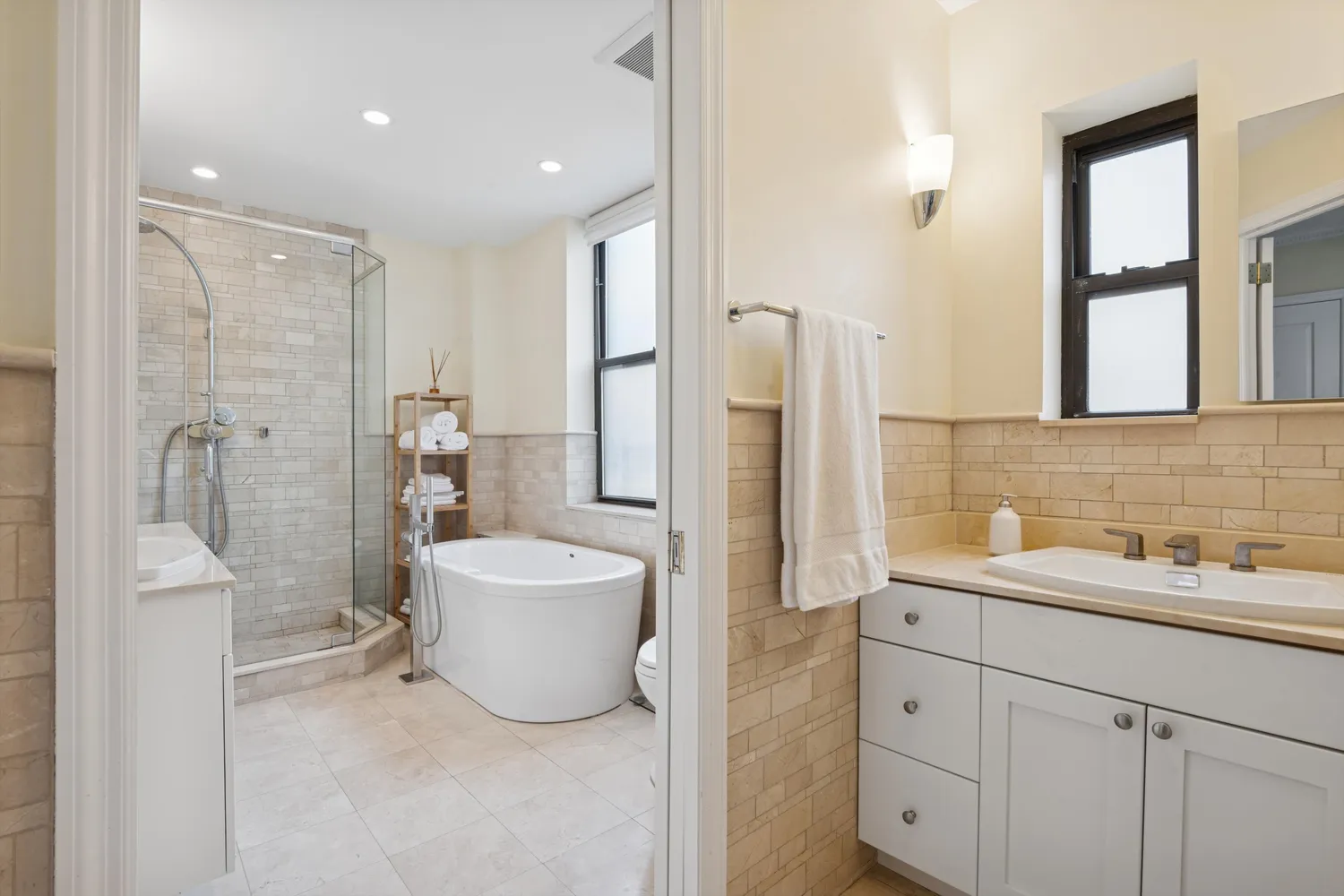 a bathroom with a double vanity sink mirror and shower