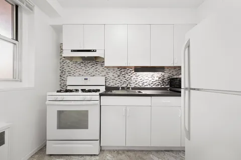 a kitchen with a refrigerator and a sink