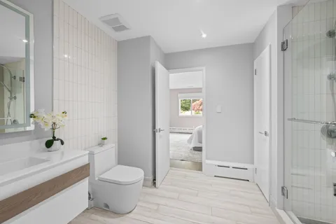 a bathroom with a toilet sink and shower