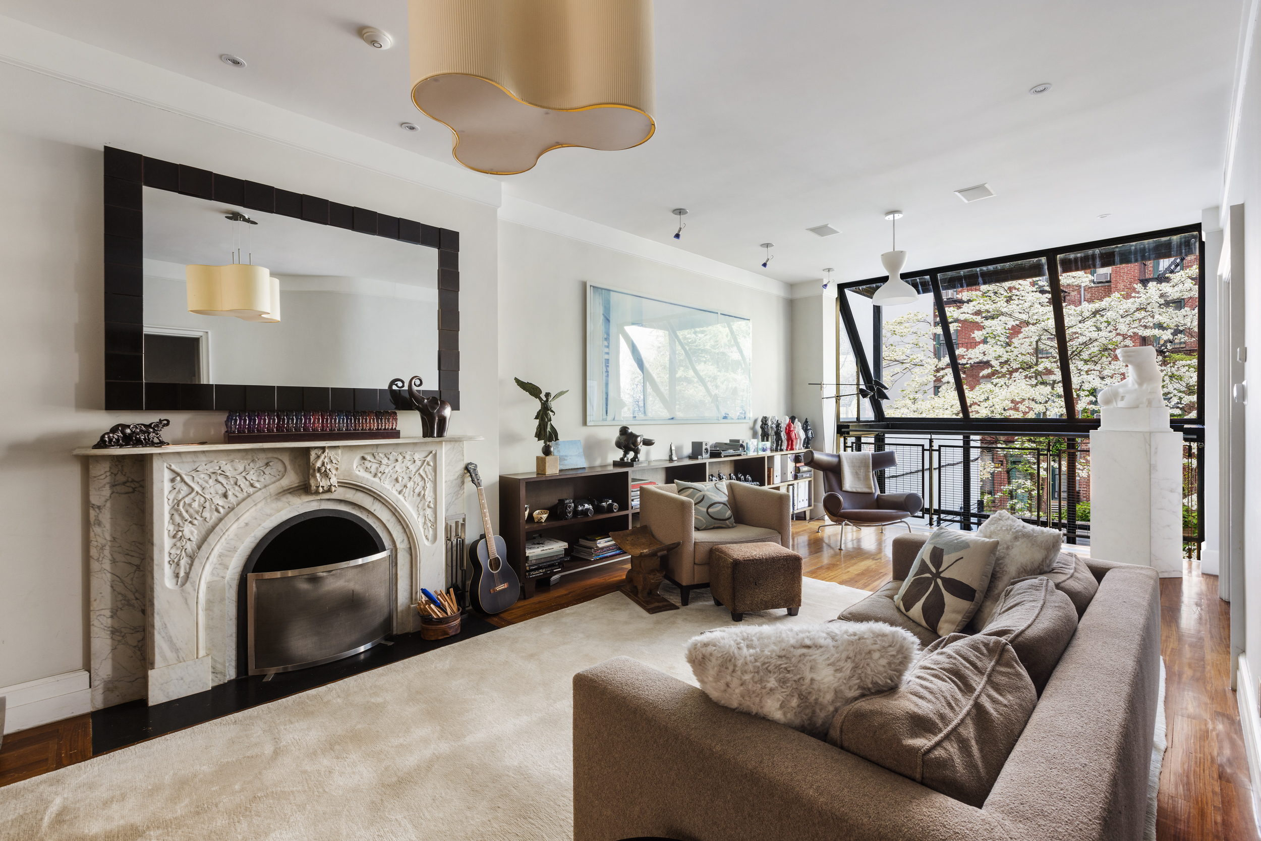 83 Jane Street Manhattan, NY 10014 - Photo 9 of 29 a living room with furniture large window and a fireplace