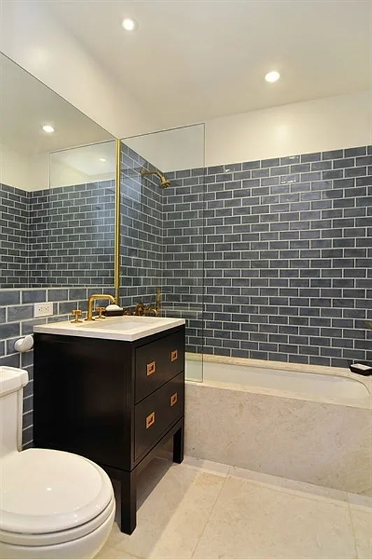 93 Worth Street, Unit 405 Manhattan, NY 10013 - Photo 4 of 18 a bathroom with a sink a toilet and shower