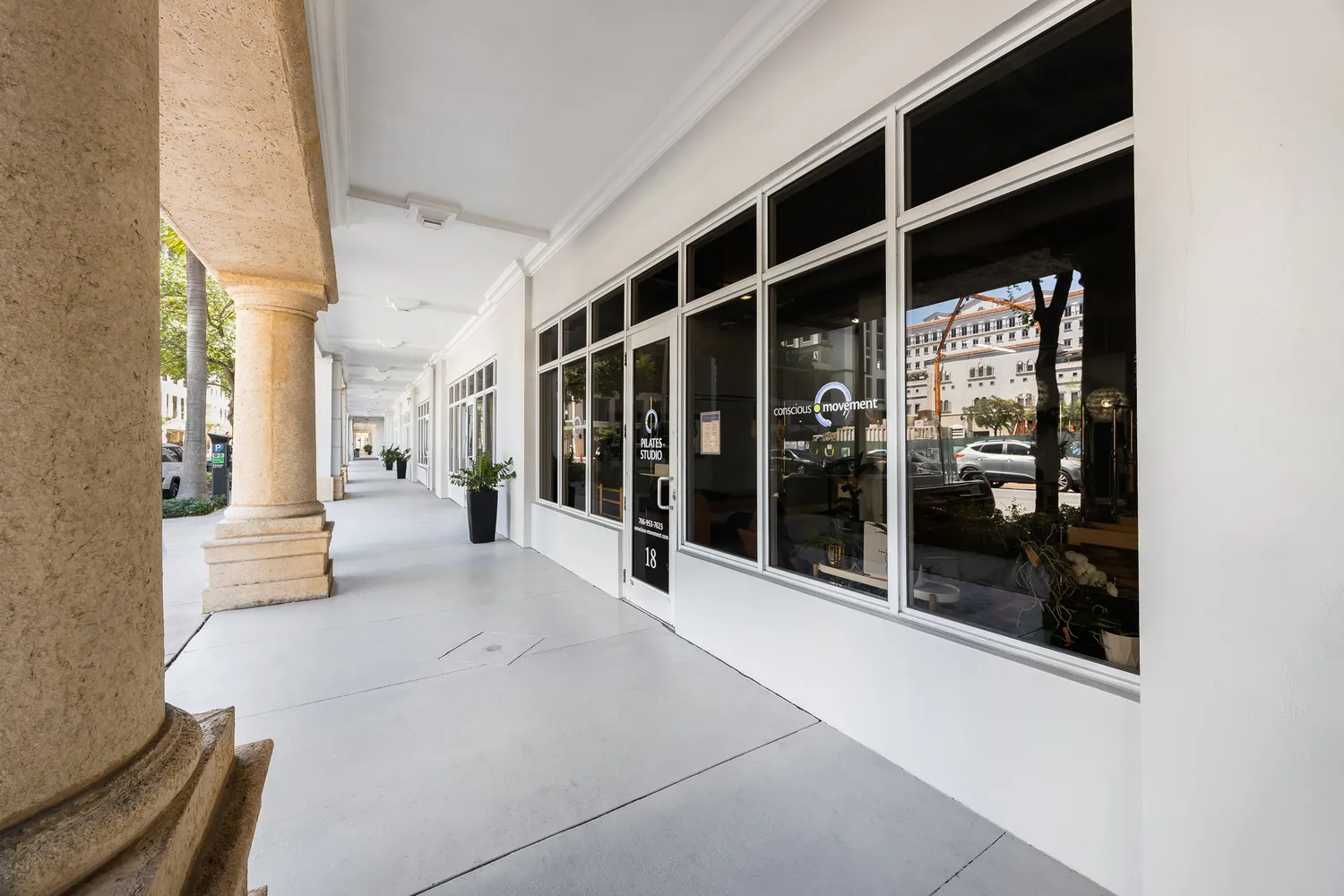 a view of a patio with couches table and chairs and potted plants