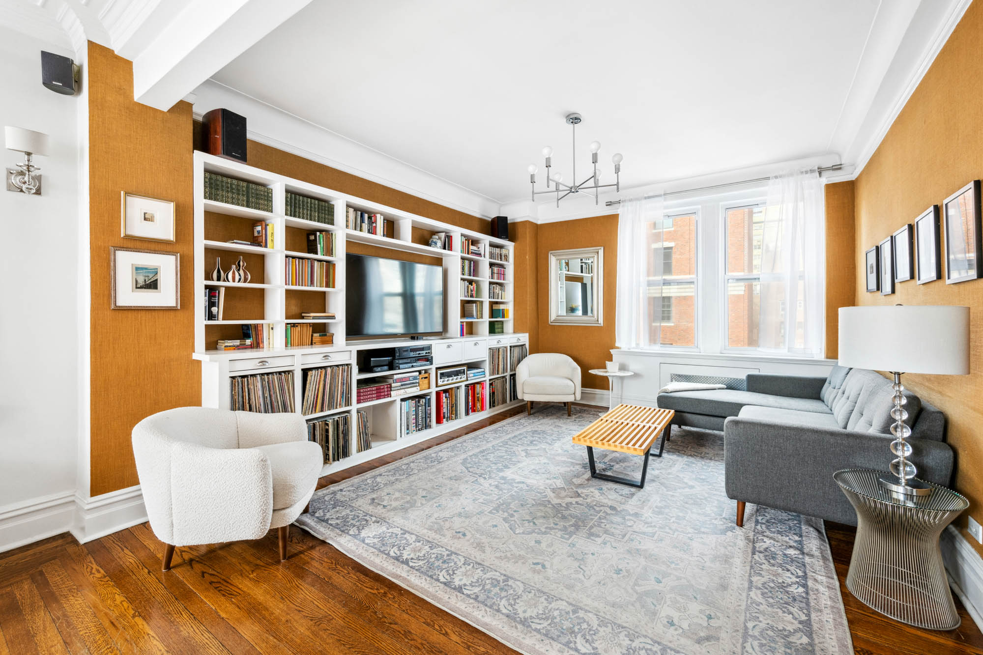 136 East 36th Street, Unit 9/10C Manhattan, NY 10016 - Photo 5 of 16 a living room with furniture windows and wooden floor