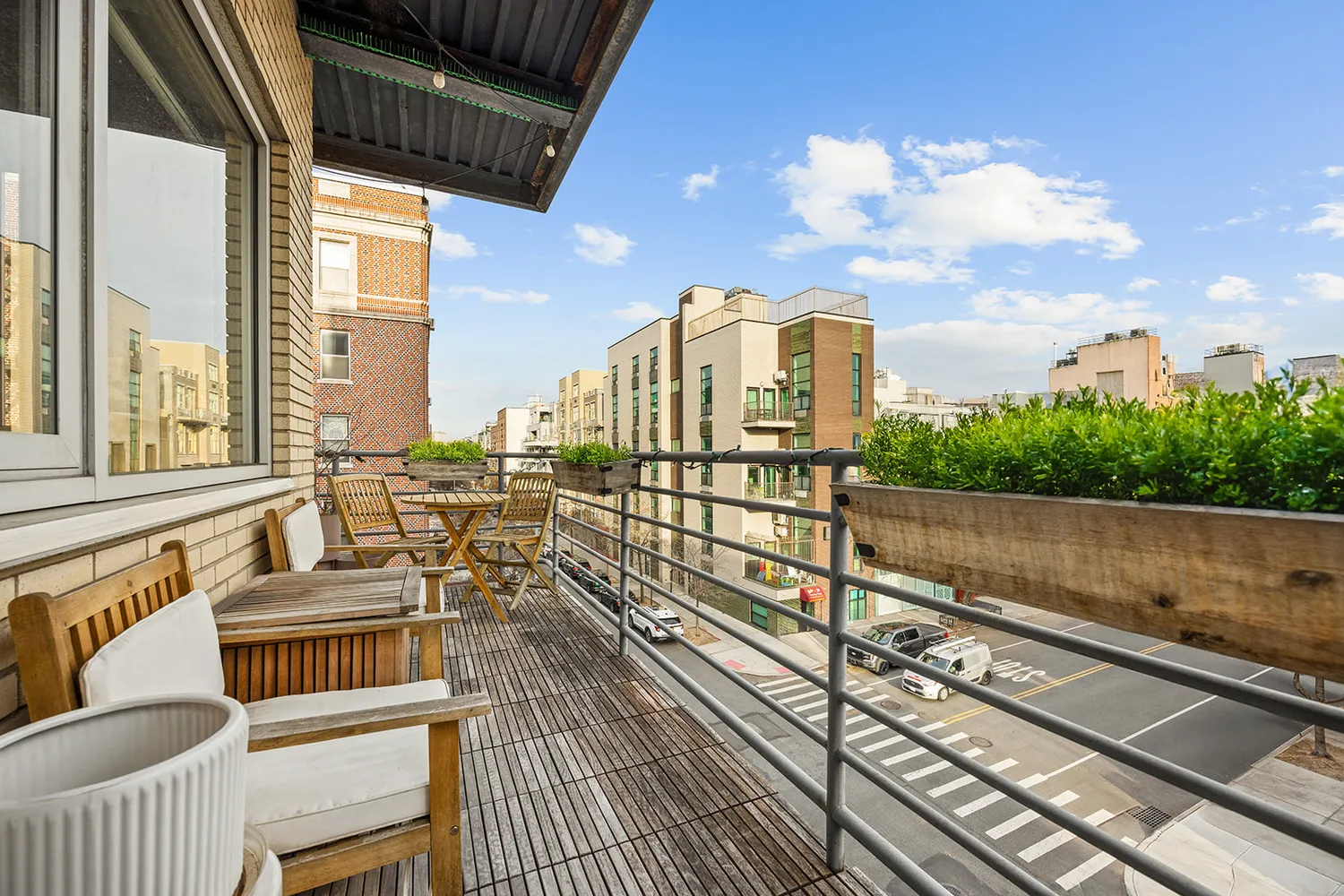 a view of a balcony with wooden floor