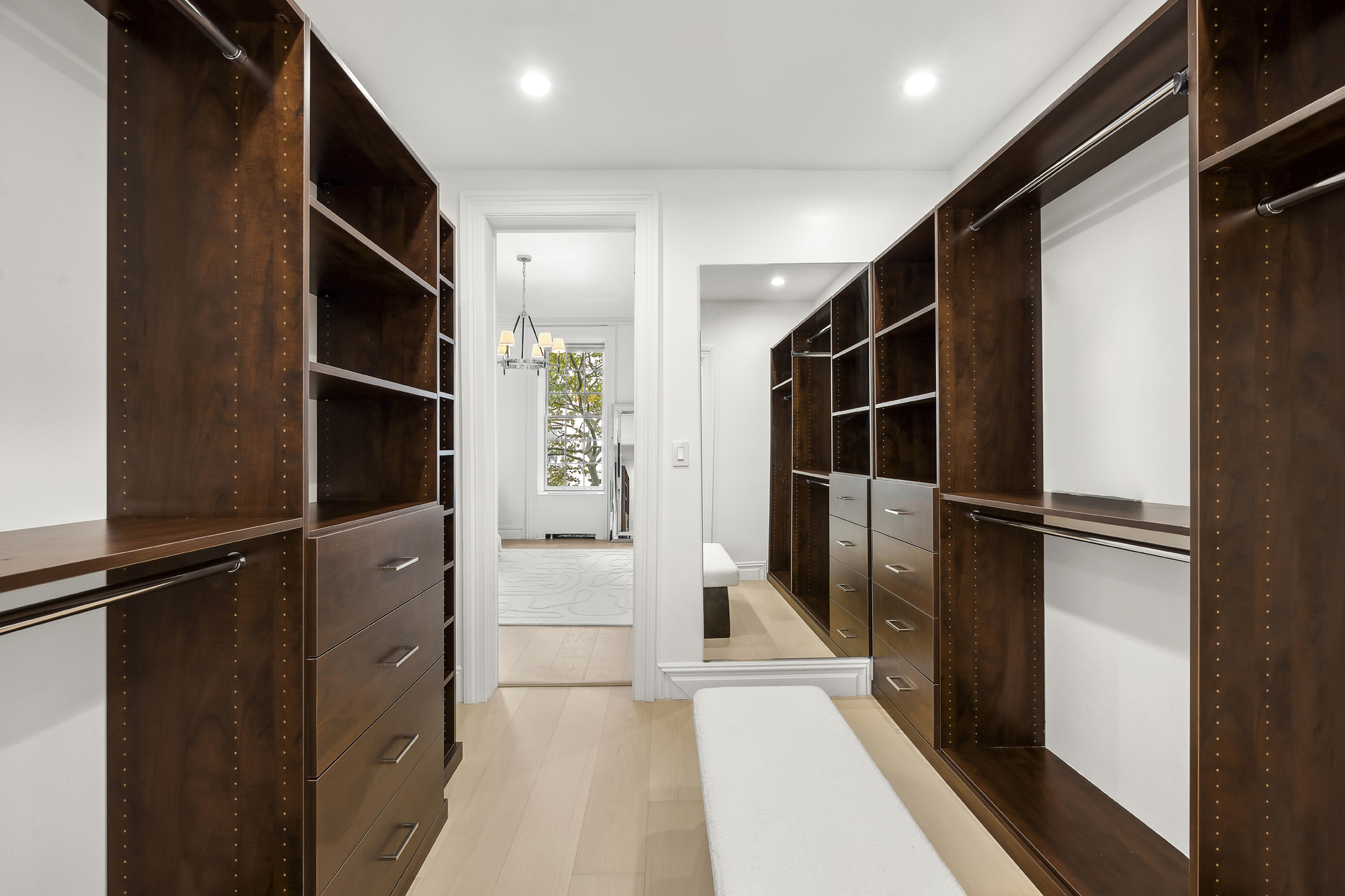 222 East 61st Street Manhattan, NY 10065 - Photo 11 of 30 a view of walk in closet with clothes and shoes