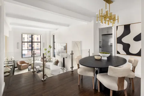a view of a dining room with furniture and chandelier