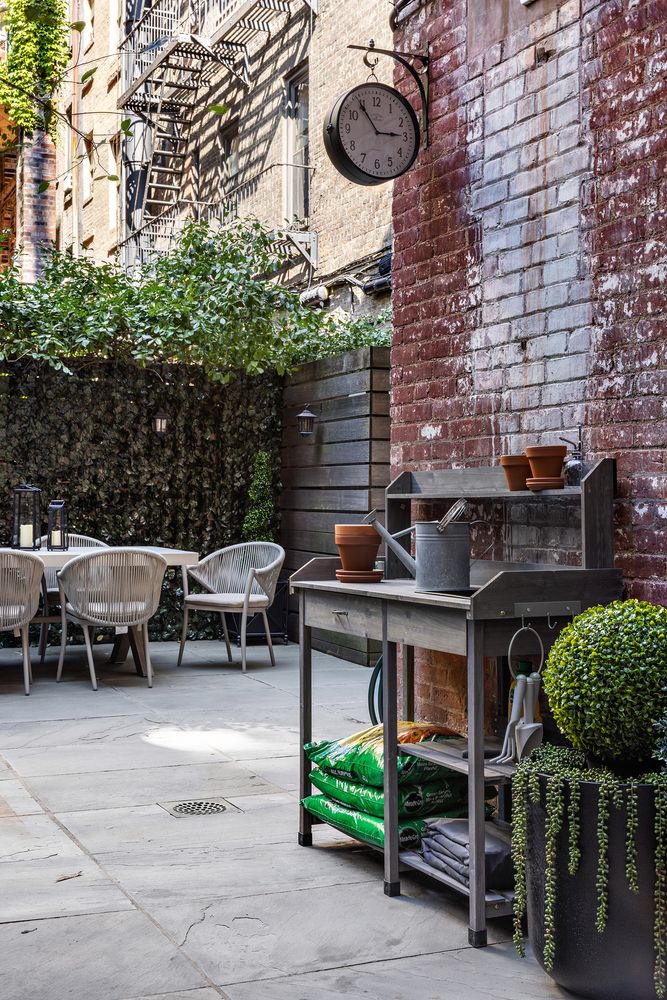a backyard of a house with table and chairs