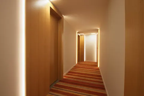 a view of a hallway with wooden floor