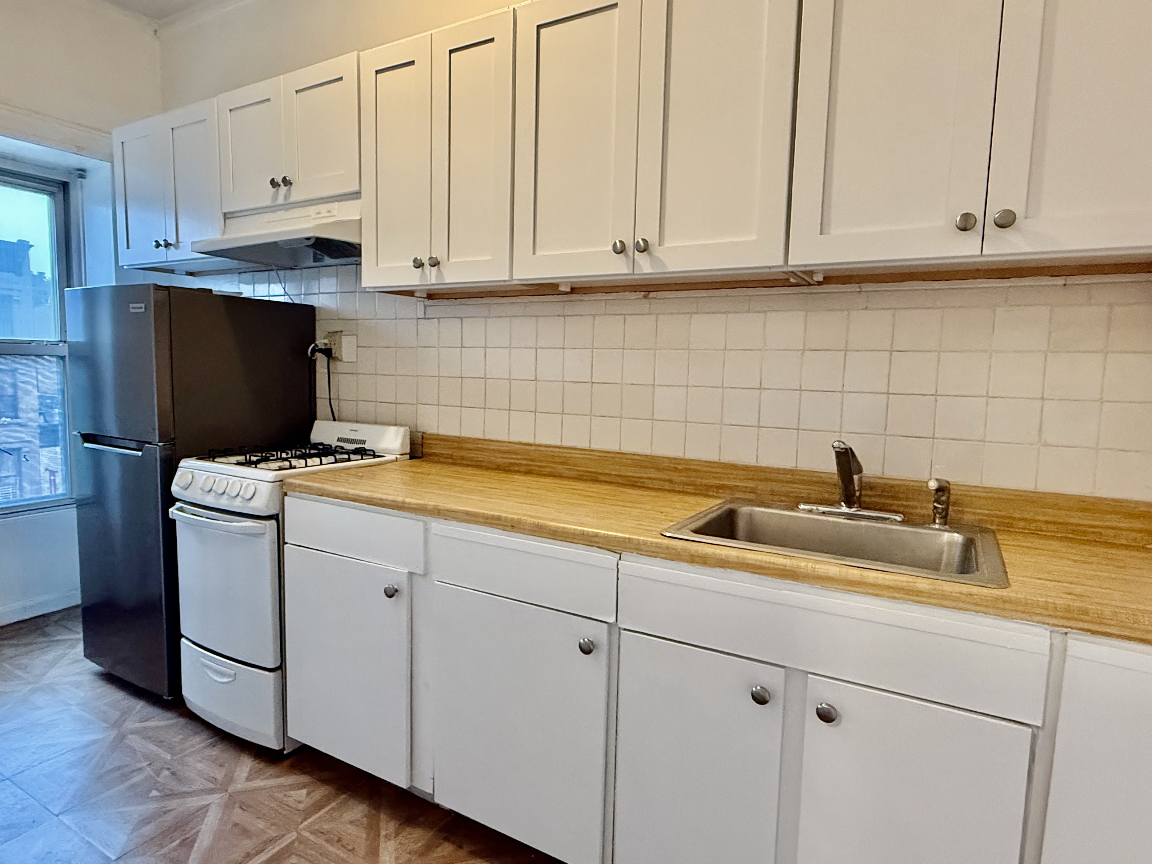 149 7th Avenue, Unit 4 Brooklyn, NY 11215 - Photo 2 of 9 a kitchen with a sink and cabinets