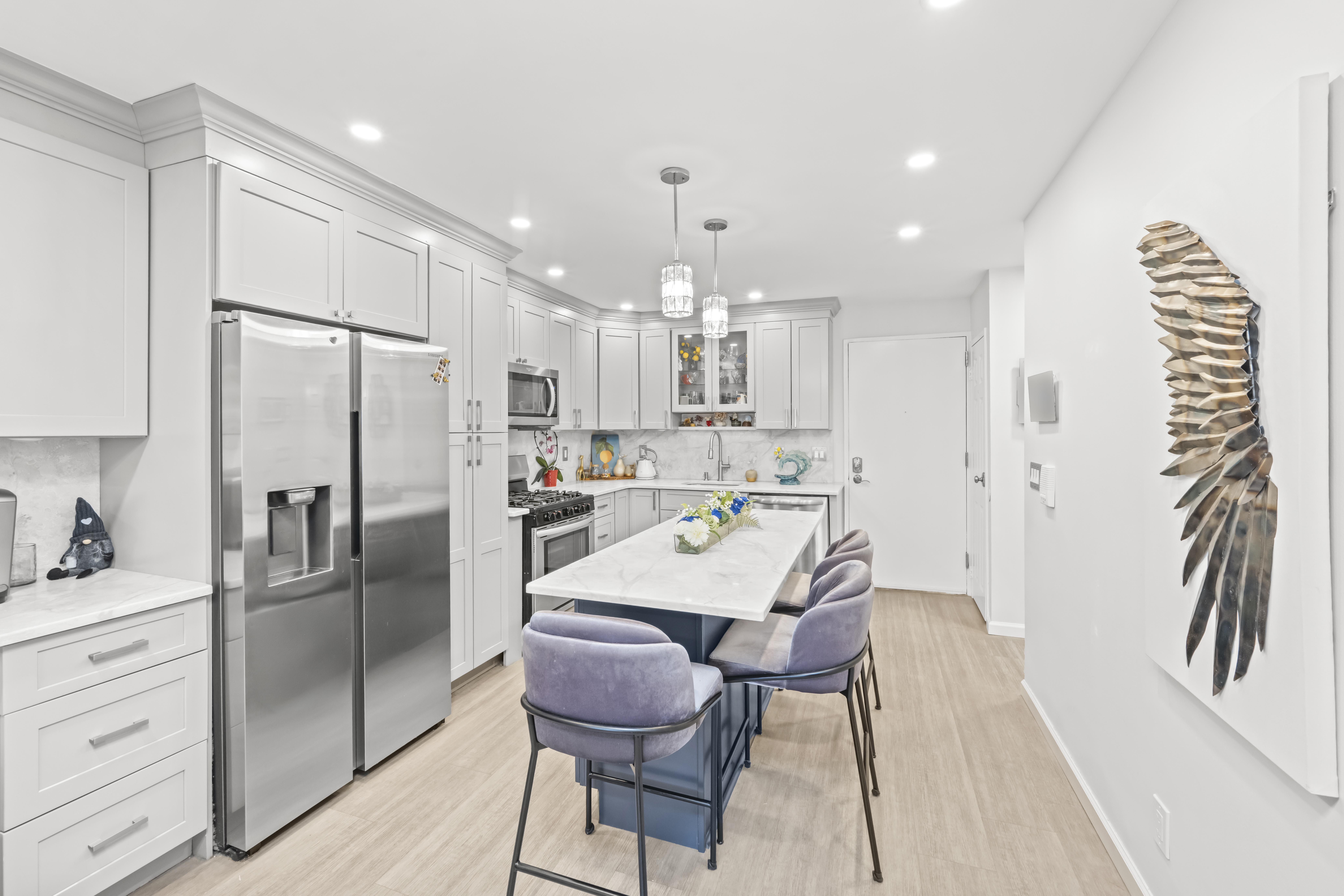 2 Elmwood Park Drive, Unit 209 Staten Island, NY 10314 - Photo 9 of 17 a kitchen with granite countertop a refrigerator a sink a stove and chairs