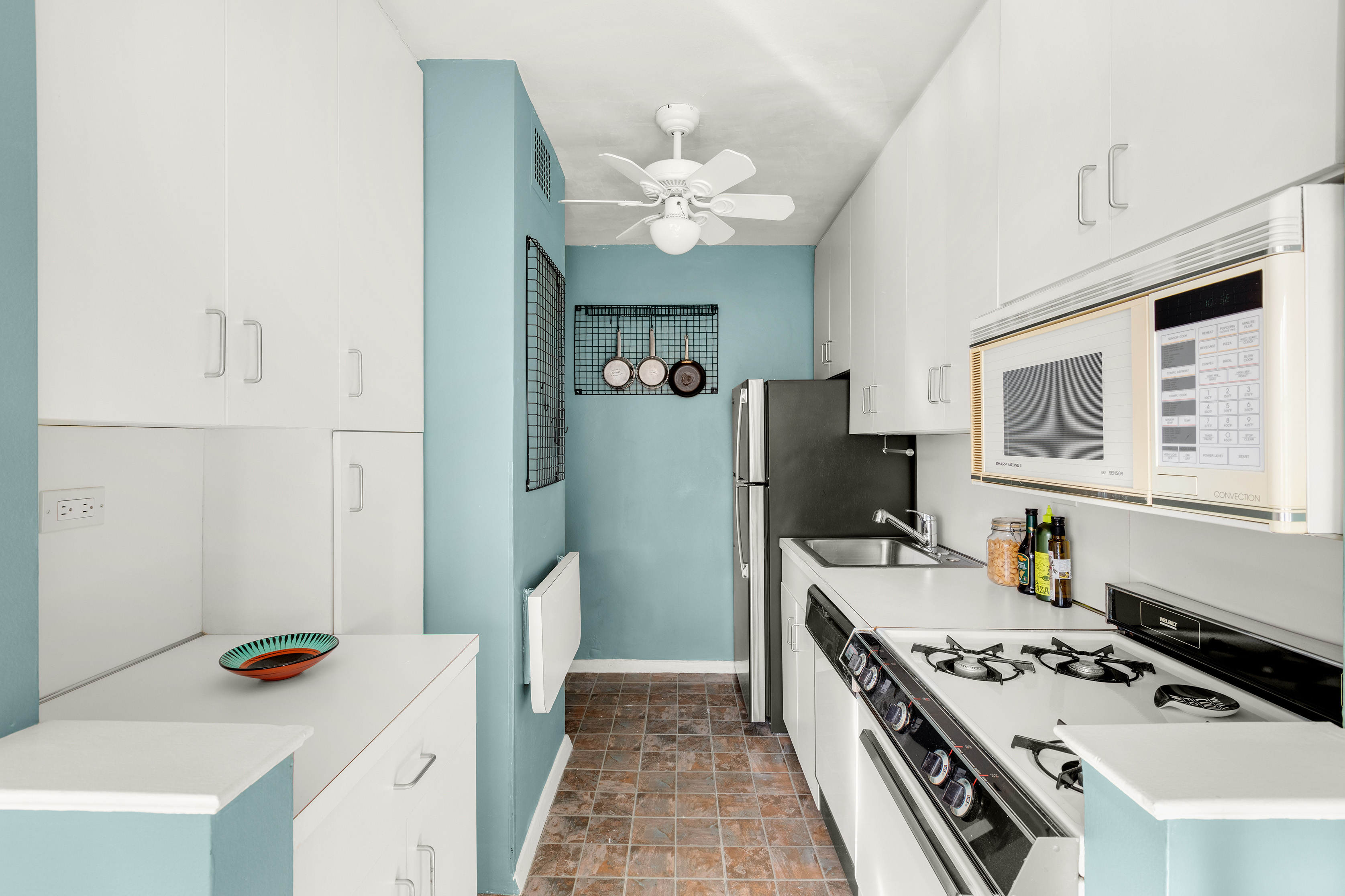 185 West End Avenue, Unit 24H Manhattan, NY 10023 - Photo 5 of 10 a kitchen with a stove and a refrigerator