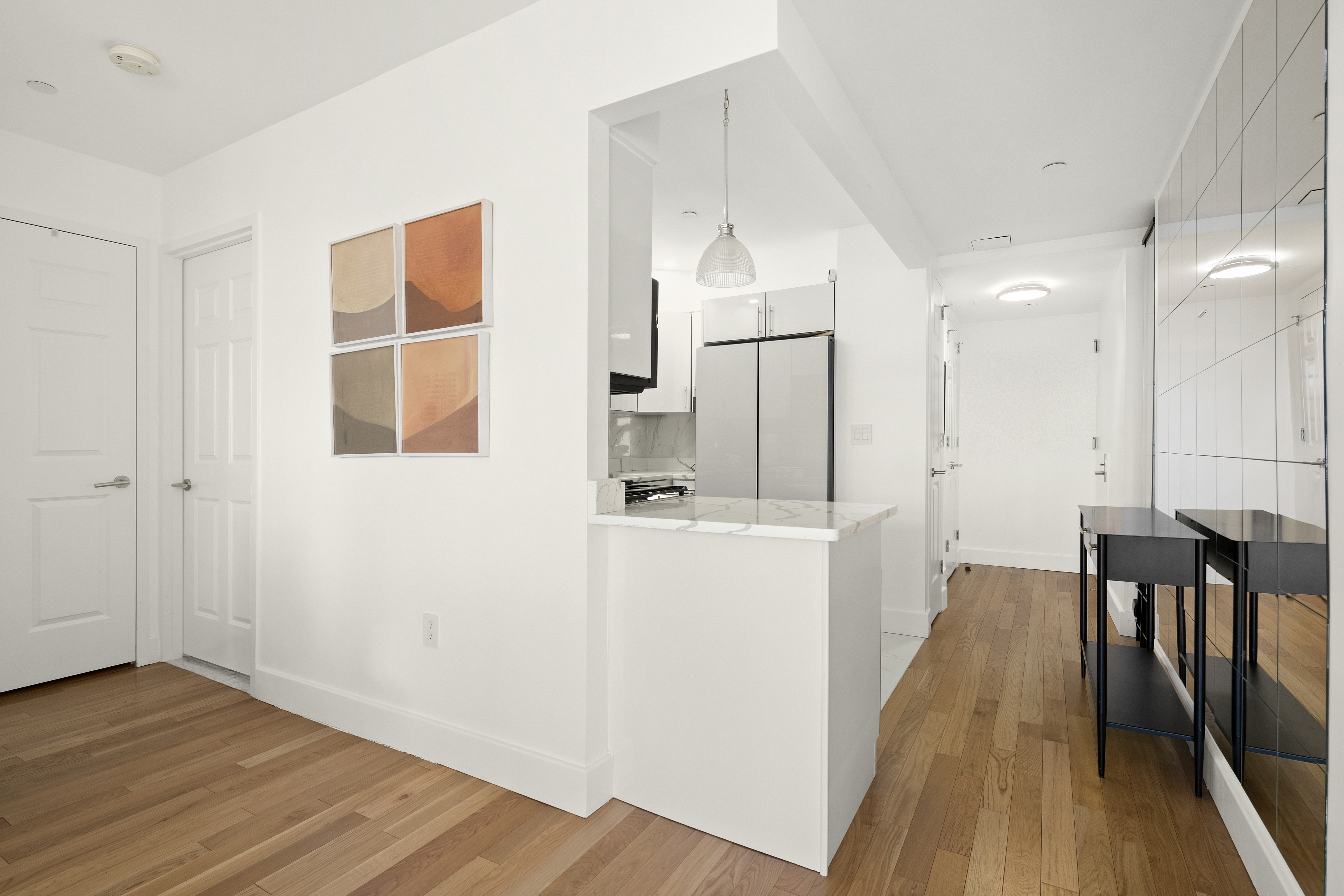 106 West 116th Street, Unit 10B Manhattan, NY 10026 - Photo 4 of 12 a view of a hallway with wooden floor and furniture