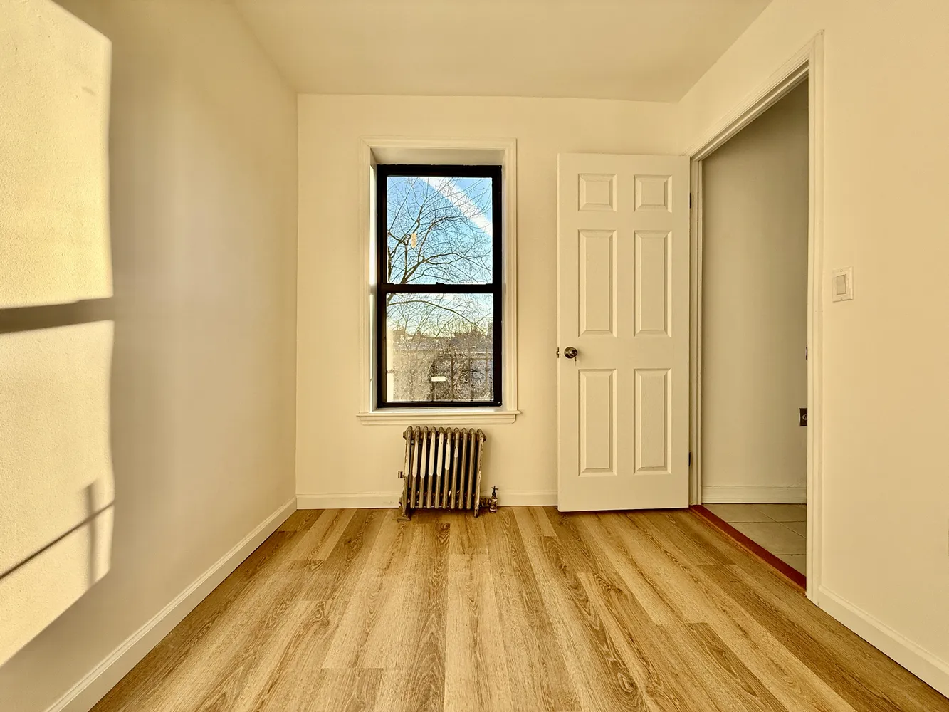 a view of a room with wooden floor and doors
