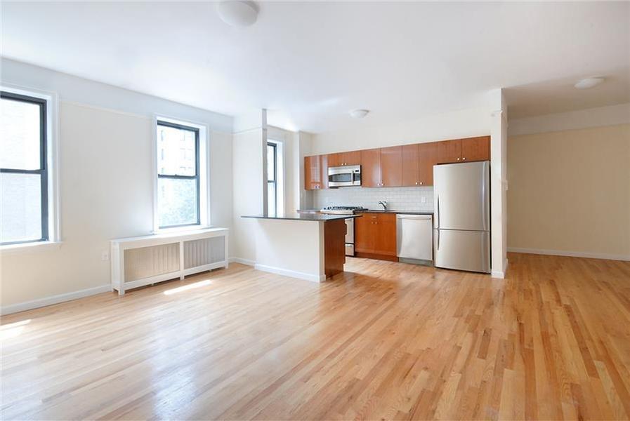 779 Riverside Drive, Unit A50 Manhattan, NY 10032 - Photo 4 of 14 a view of a kitchen with wooden floor and a window