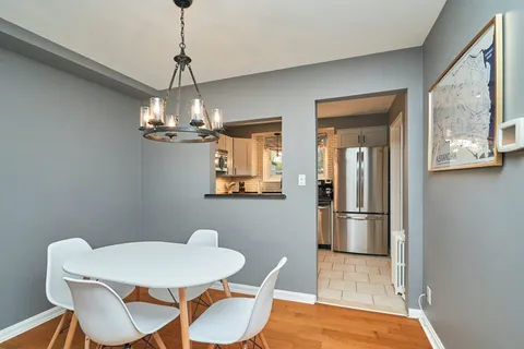 a view of a dining room with furniture and chandelier