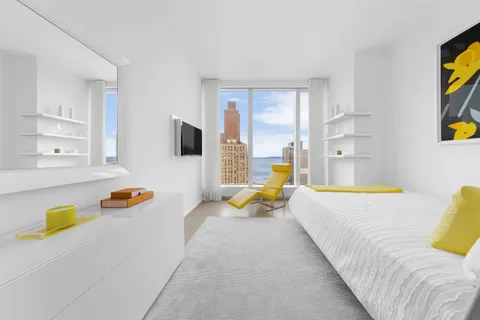 a bedroom with a bed and a couch