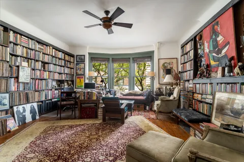 a living room with furniture or couch and a bookshelf