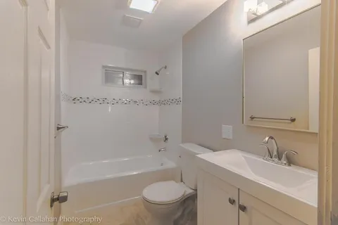 a bathroom with a sink a toilet and a bathtub