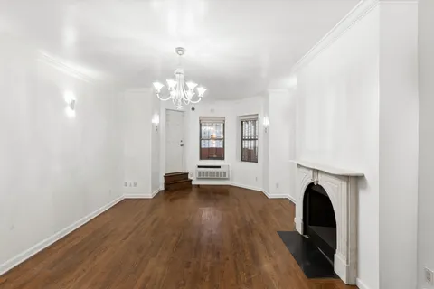 a view of livingroom with fireplace and wooden floor