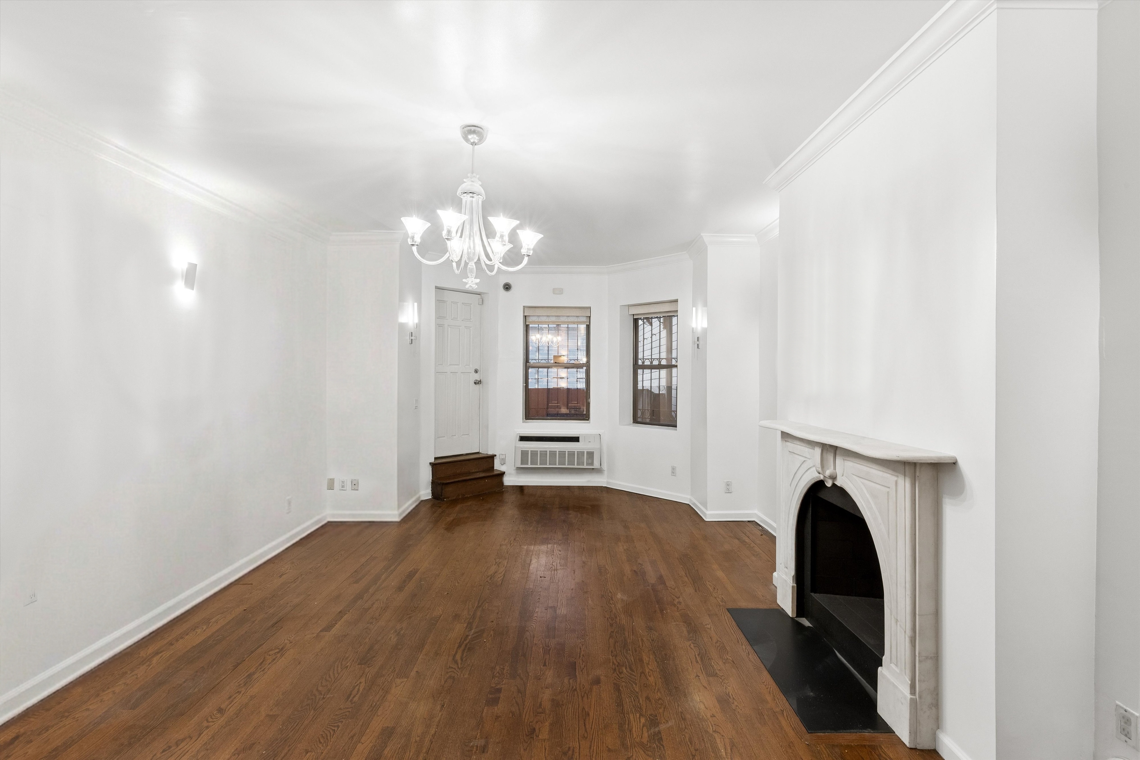 165 West 126th Street Manhattan, NY 10027 - Photo 8 of 40 a view of livingroom with fireplace and wooden floor