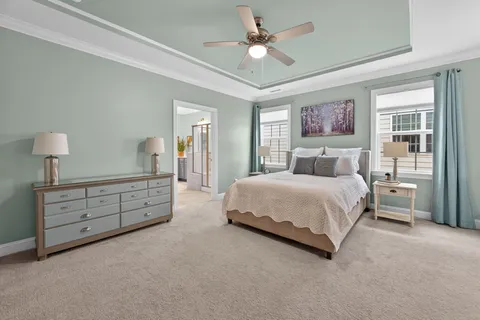 a bedroom with a large bed and a chandelier